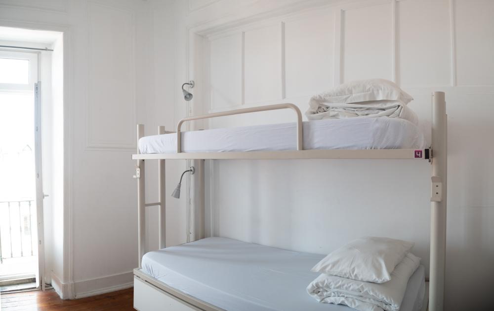 Cama en un dormitorio femenino compartido de 6 camas con baño compartido